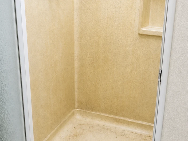 Cracked, flexing fiberglass shower pan with a stress crack near the drain before repair, Santa Clara